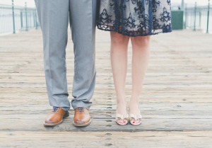 Couple standing on a pier - leg shot